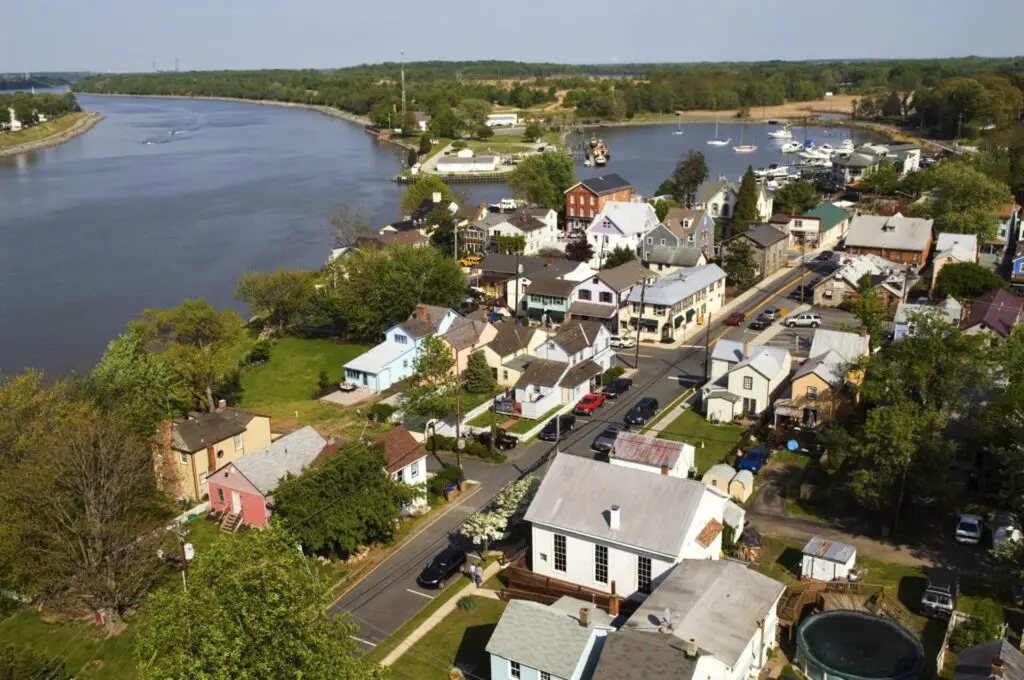 Aerial view of homes and wooded lots beside a winding waterway