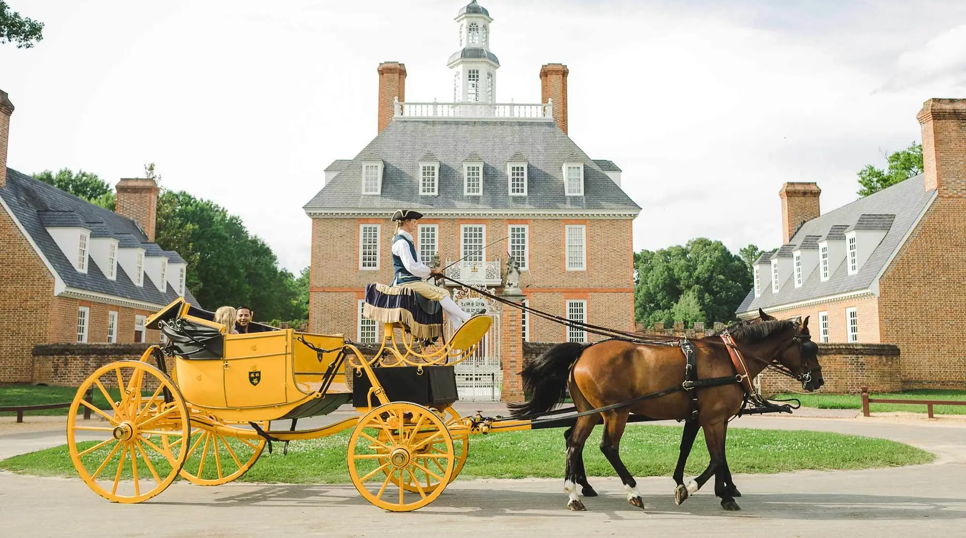 Horse-drawn carriage passing in front of the Governor’s Palace at Colonial Williamsburg