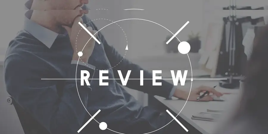 Person reviewing documents at a desk with a review graphic