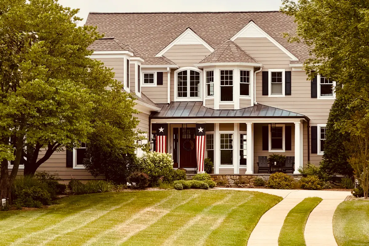 House with a front porch, lawn, and driveway