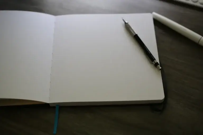 Open notebook with a pen on the pages