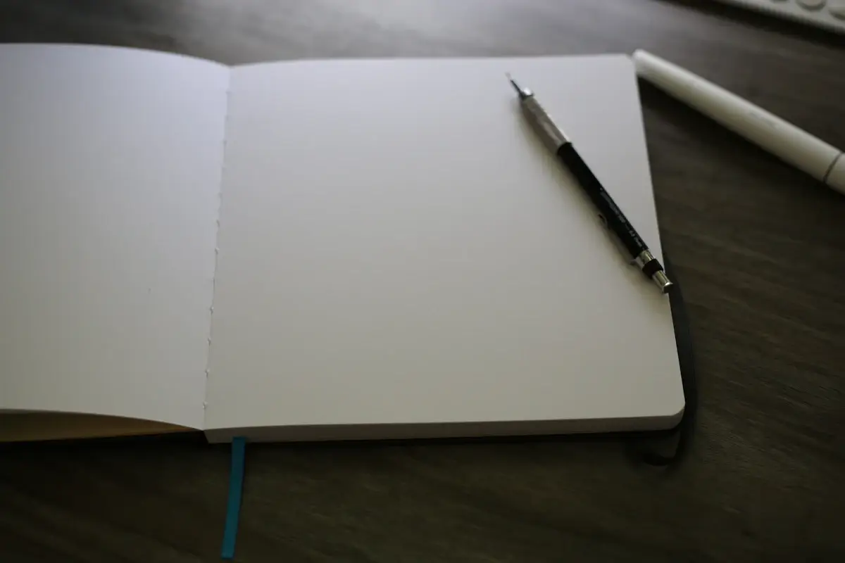 Open notebook with a pen on the pages