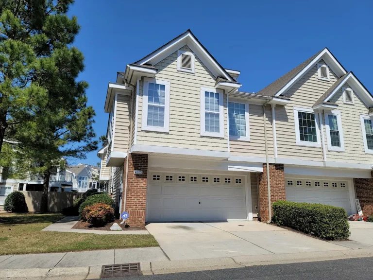 Attached cream-colored residences with front garages