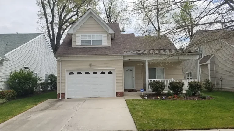 Beige gabled home with a single garage and covered entrance