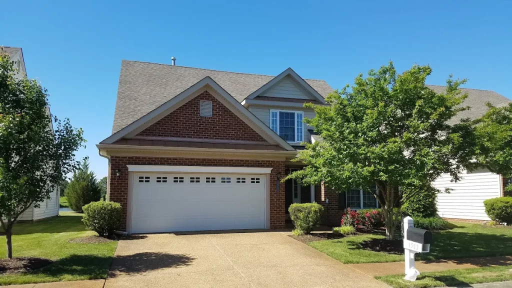 Gabled brick home with a double garage and front lawn