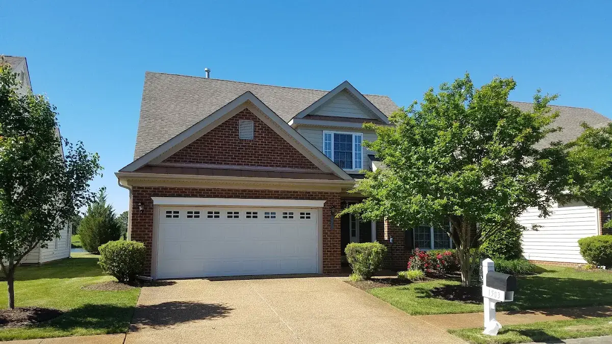 Gabled brick home with a double garage and front lawn