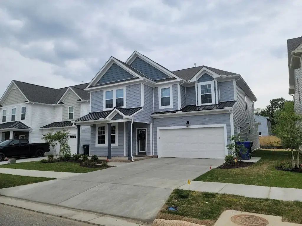 Gray two-story home with white trim and a double garage
