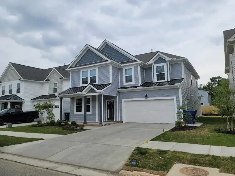 Gray two-story home with white trim and a double garage