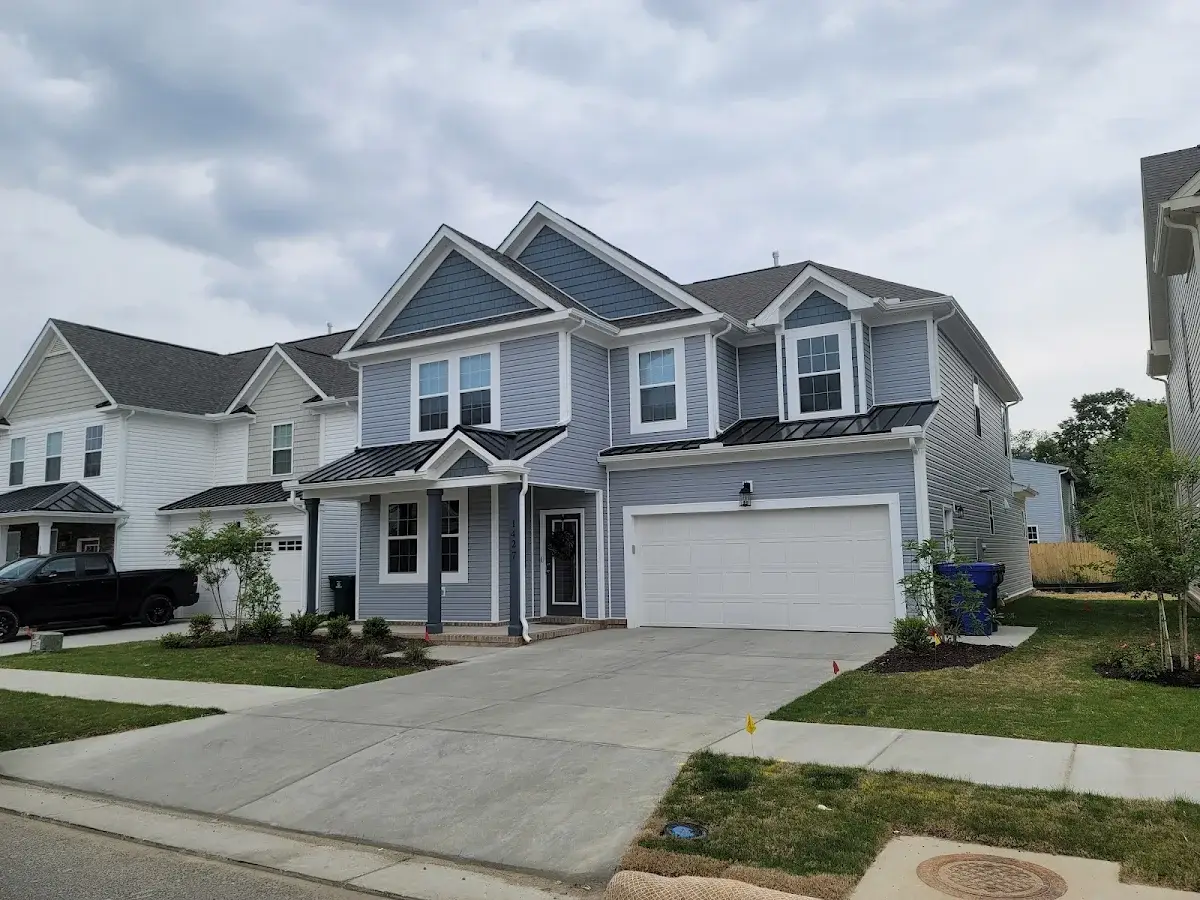Gray two-story home with white trim and a double garage