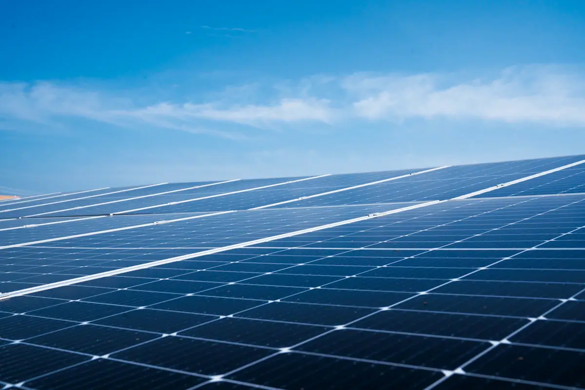 Rows of solar panels beneath a blue sky
