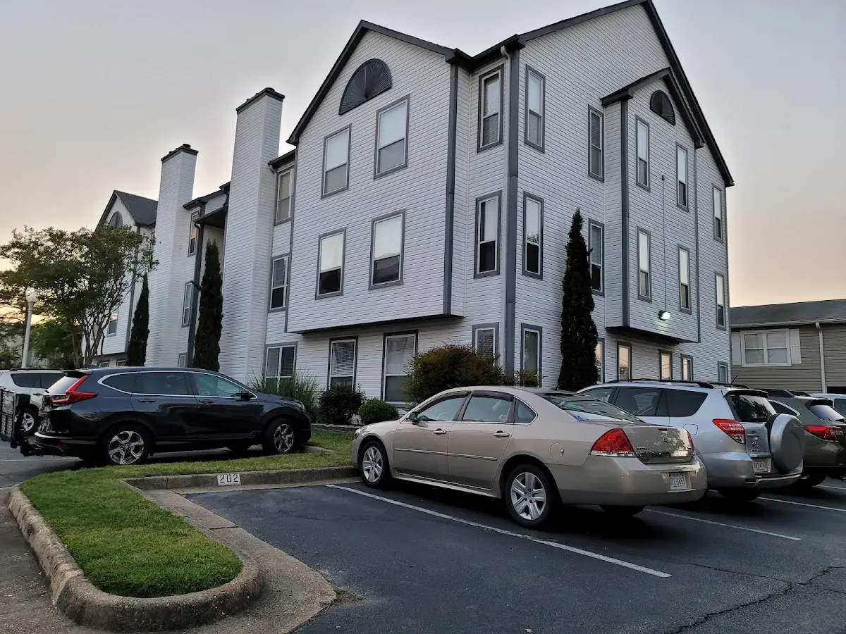 Three-story gray residential building with balconies