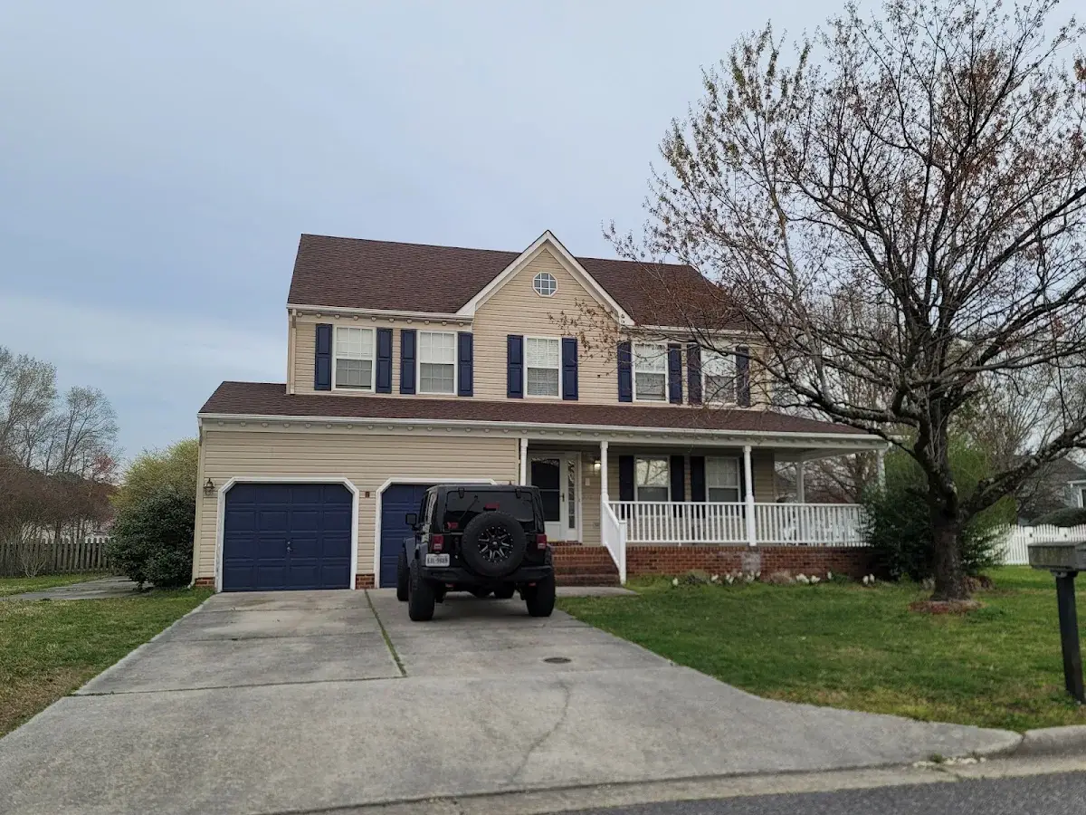 Yellow two-story home with a covered front porch
